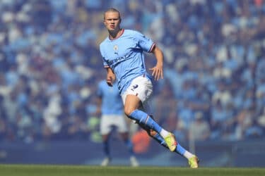 Erling Haaland running on football pitch for Premier League Manchester City